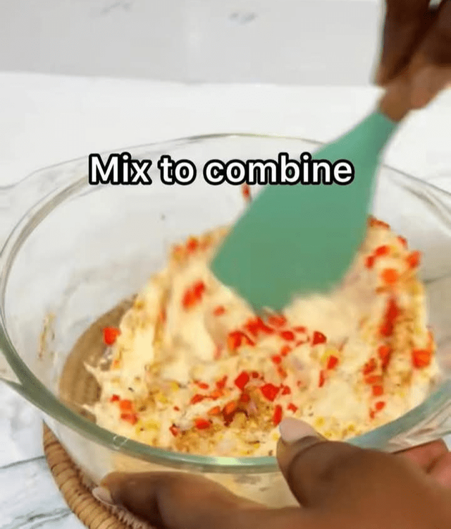 Step 1.1: Add the chopped peppers, onion, salt, seasoning cubes, and ground crayfish to the grated water yam in the bowl