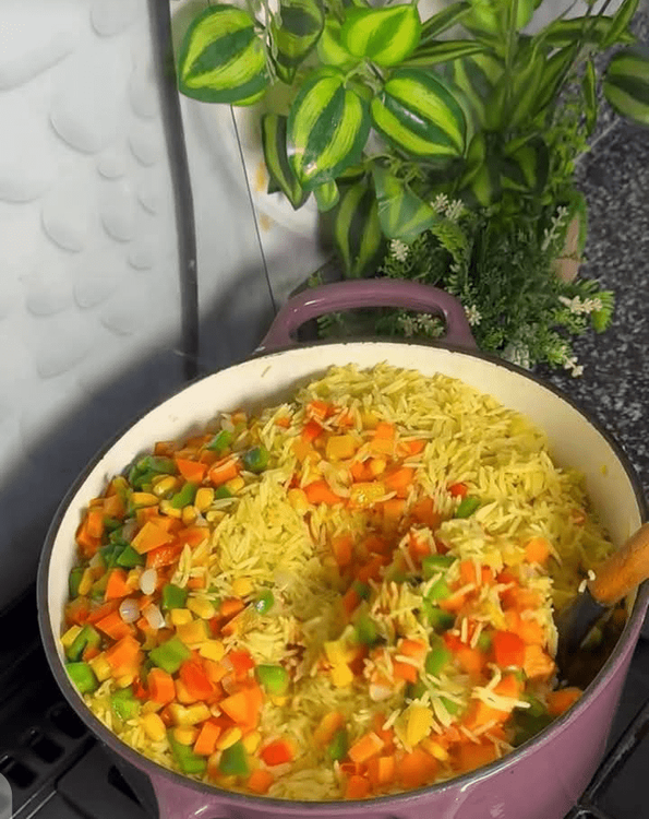 Step 2.2: Once the rice is cooked, add the mixed vegetables and stir well to combine