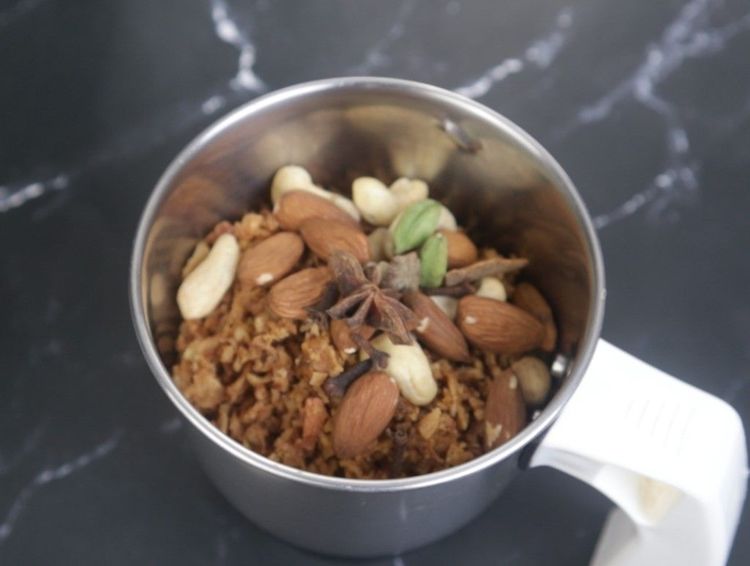 Step 2.1: In a mixie jar, add fried golden brown onions, cashews, almonds, and curd