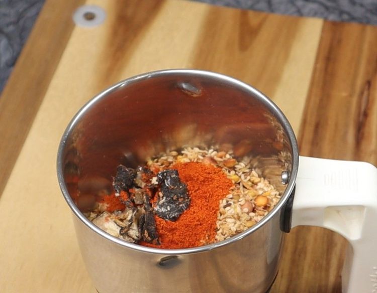 Step 2.1: Let it cool slightly, then grind with red chilli powder, salt, turmeric, and ginger-garlic paste to a coarse powder