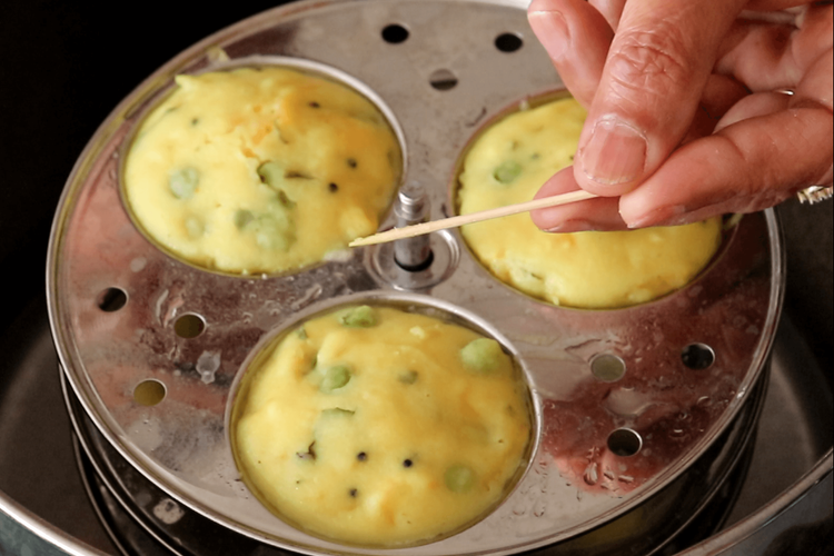 Step 4.1: To check doneness, insert a toothpick into the centre of an idli; it should come out clean