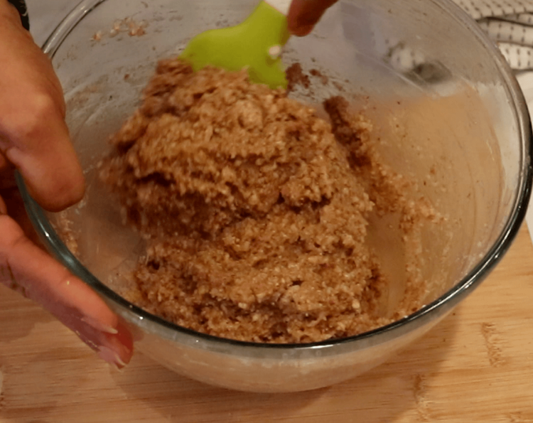 Step 1.3: Add the lemon zest to the bowl and gradually fold the almond-sugar mixture into the whisked egg white, gently combining with a spatula to form a dough