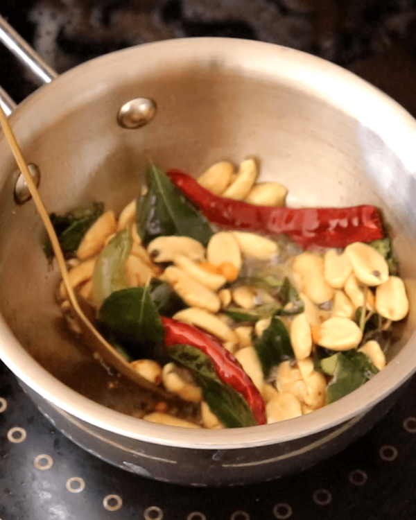 Step 2.1: Stir in asafoetida, broken dry red chillies, and curry leaves