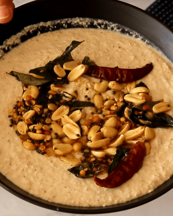 Step 2.1: Pour the tempered mixture over the prepared coconut chutney and mix well