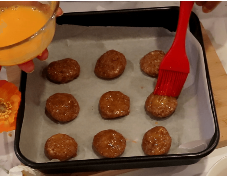 Step 1.1: Brush the tops with the reserved egg yolk for a golden finish