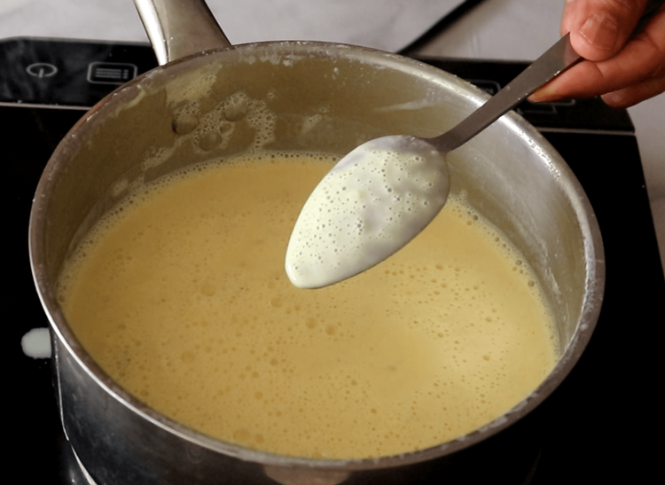 Step 2.2: Add saffron strands and stir until the milk thickens slightly to a creamy consistency