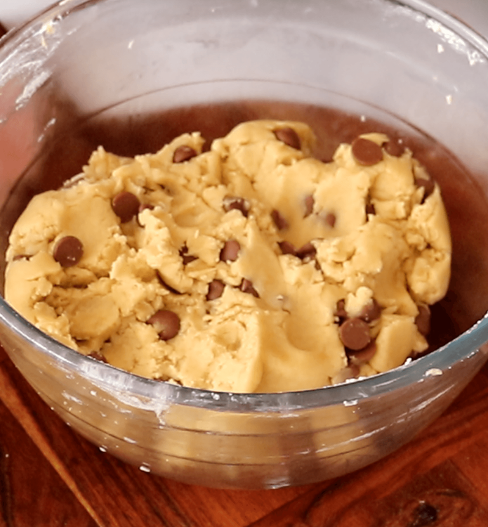 Step 1.2: Stir in the chocolate chips, ensuring they are evenly distributed by gently kneading the dough
