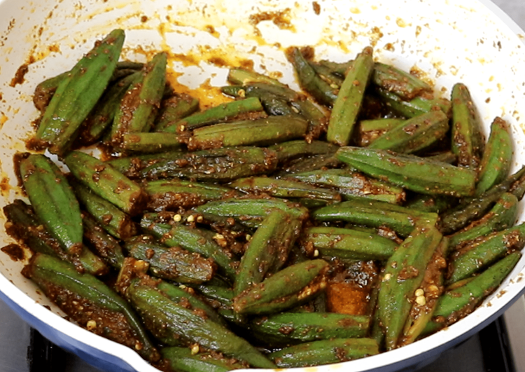 Step 4.1: Continue cooking on low to medium heat, turning occasionally, for 15-20 minutes or until the bhindi is soft, tender, and slightly crisp at the edges