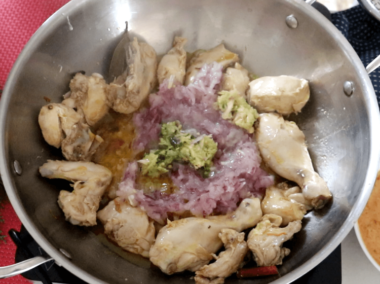 Step 2.1: Move the chicken pieces to the sides of the wok