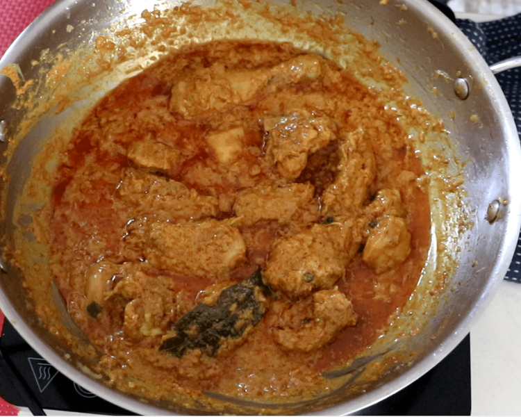Step 2.1: Lower the heat to a gentle simmer, cover the pan, and cook until the chicken is fully tender and the oil rises to the surface of the gravy
