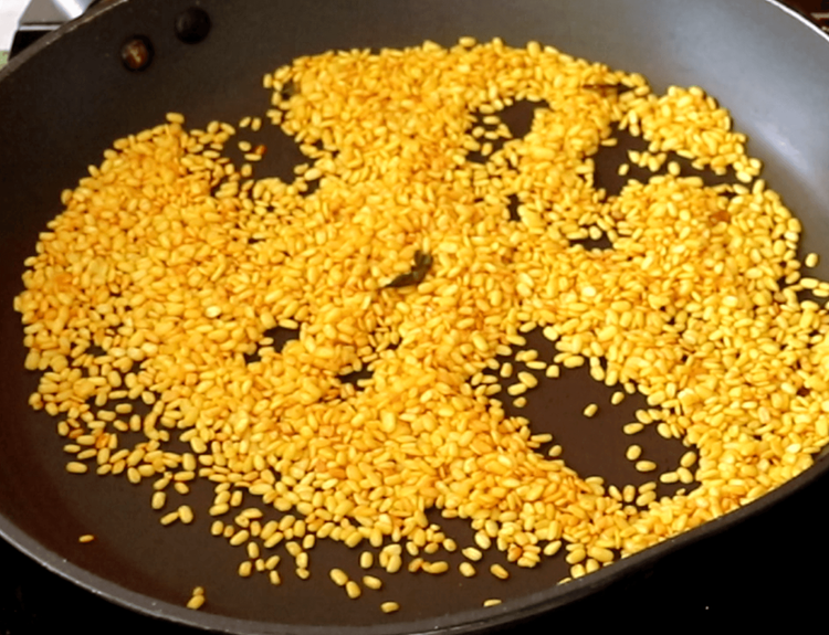 Step 2.1: Next, roast the soaked urad dal with turmeric powder until golden and crunchy