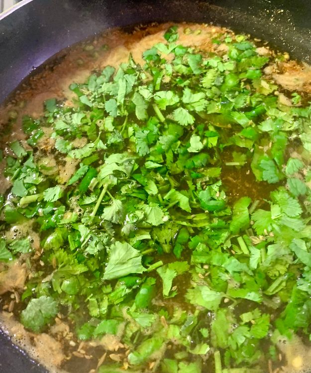 Step 1.1: Reduce the flame, add green coriander and stir