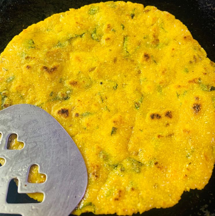 Step 2.1: Brush the roti with a little oil, flip it on the tawa/skillet, and press gently with a flat spatula