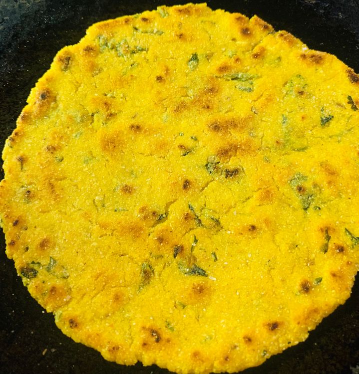 Step 2.3: Drizzle little oil on the tawa/skillet and place the cornmeal roti on it