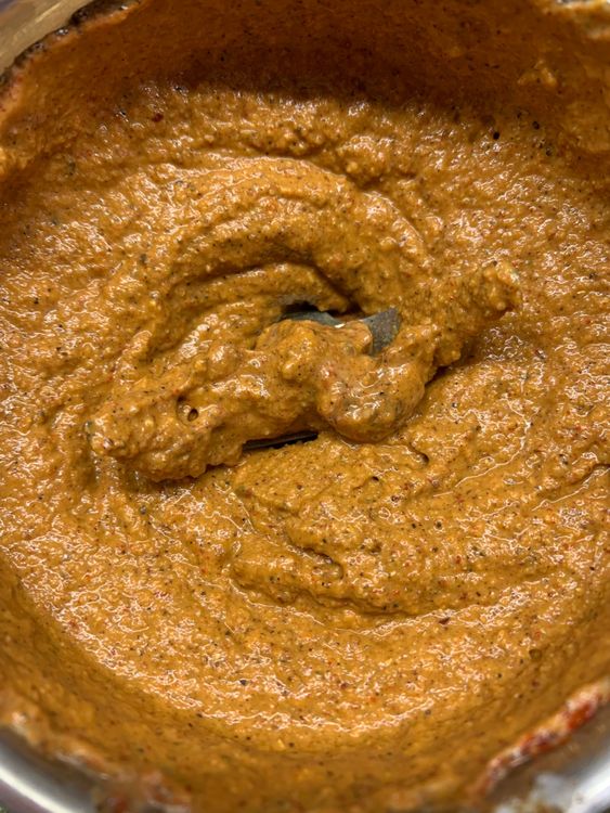 Step 1.1: Add desiccated coconut, kashmiri red chilli, ginger, garlic cloves, green chilli, curd, tamarind paste and salt to the ground spices, and blend to make a fine paste