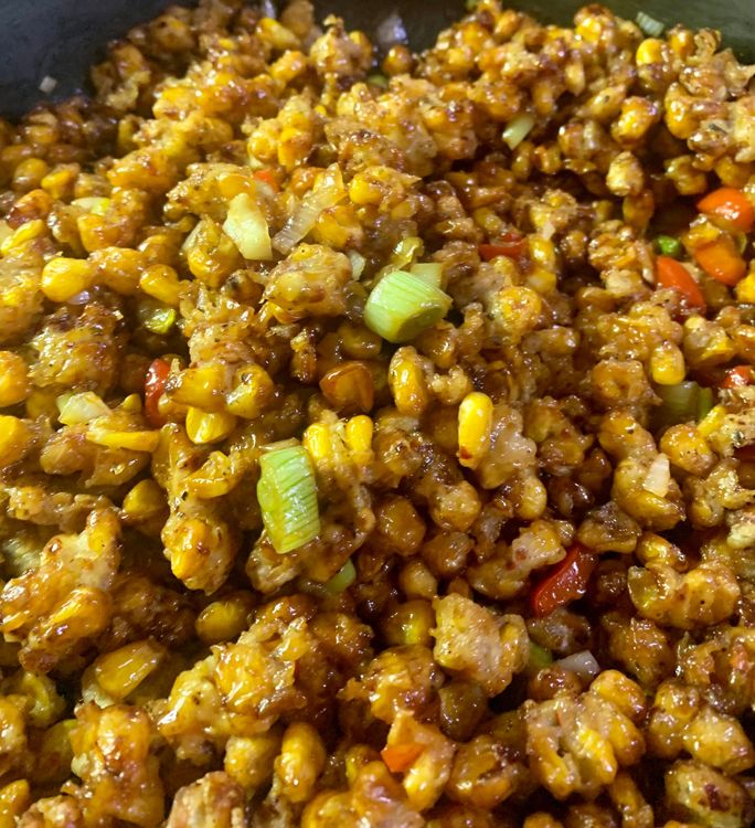 Step 2.1:  Stir the corn kernels into the mixture until they are evenly coated with the vegetables and sauce