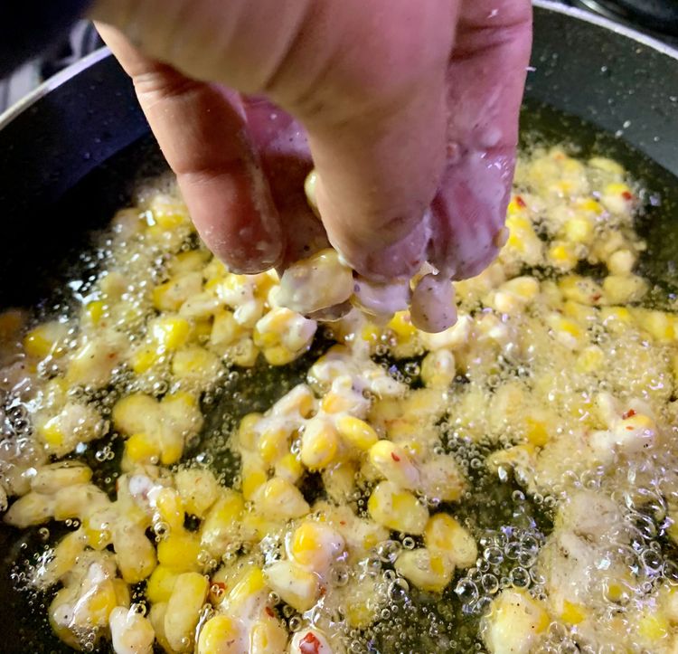 Step 1.1: Once the oil is hot, carefully add the corn kernels to the pan in small batches