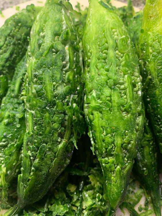 Step 1.1: Scrape and slit the bitter gourds (karela) lengthwise/vertically and scoop out the seeds