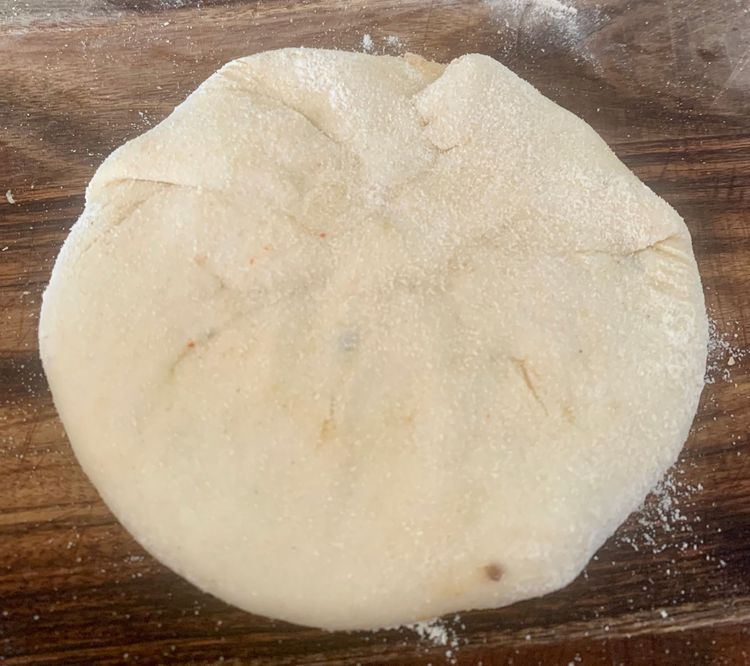 Step 3.3: Place a portion of the prepared stuffing and seal all sides of the dough together to form a ball