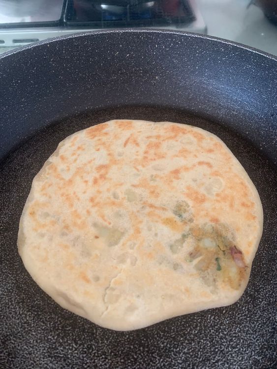 Step 5.1: Drizzle little oil on the skillet and place the stuffed naan, and cook for 3-4 minutes