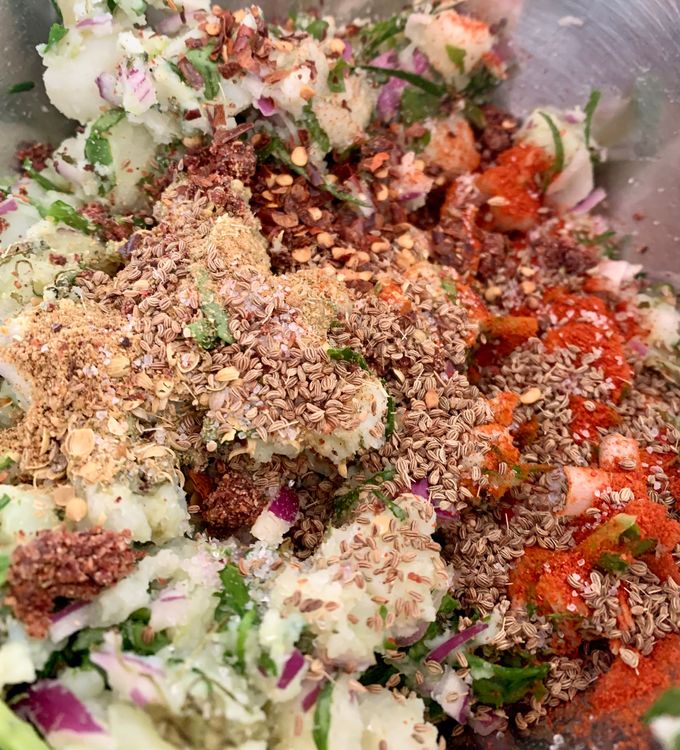 Step 1.2: Add chopped spinach, onions, green chillies, ginger, red chilli powder, red chilli flakes, coriander powder, cumin powder, mango powder, garam masala, carom seeds, fenugreek leaves, coriander leaves and salt