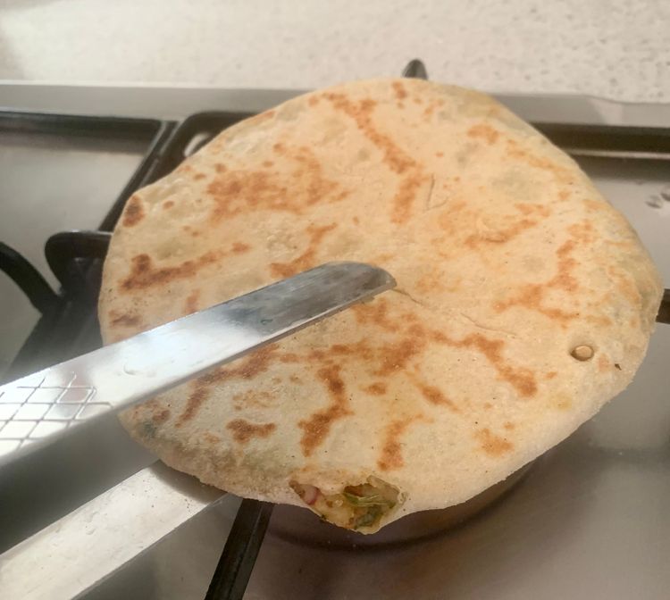 Step 4.1: Hold the naan with a tong