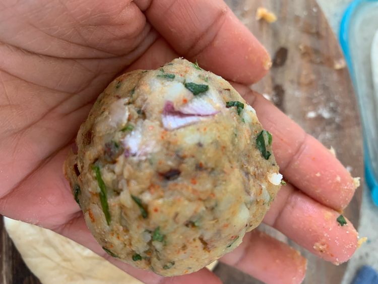 Step 3.1: Place a portion of the prepared stuffing and seal all sides of the dough together to form a ball