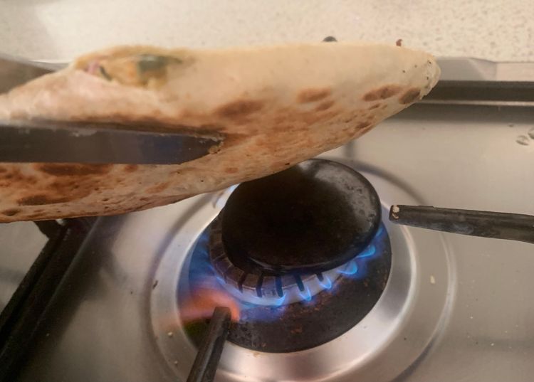 Step 4.3: Hold the naan with a tong