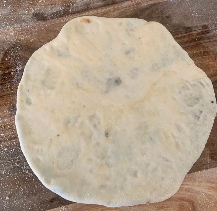 Step 3.1: Gently roll the rolling pin over it till the dough takes a round shape (approx