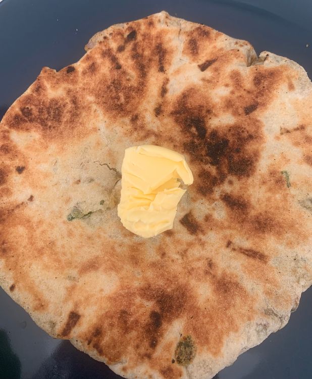 Step 4.4: Hold the naan with a tong