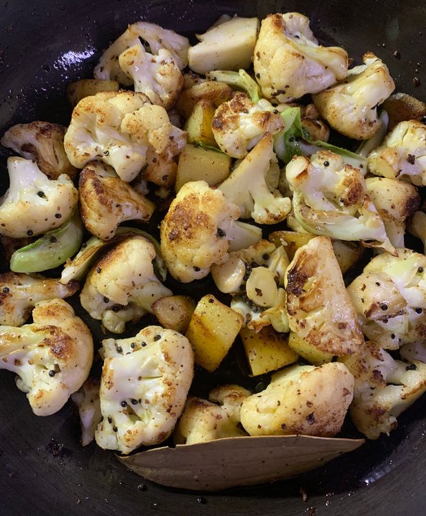 Step 3.3: Add the cauliflower florets and potatoes to the pan