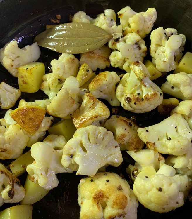 Step 3.2: Add the cauliflower florets and potatoes to the pan