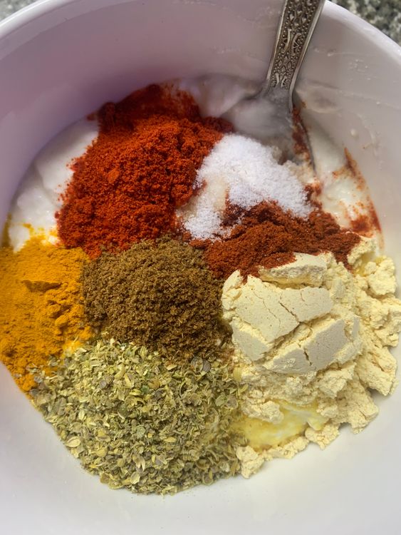 Step 2.1: Mix curd, gram flour, red chilli powder, kashmiri red chilli powder, coriander powder, cumin powder, turmeric, salt and water in a mixing bowl