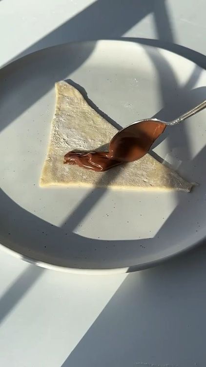 Step 1.1: Add a little bit of Nutella to each triangle and roll them up from the wide end to the tip
