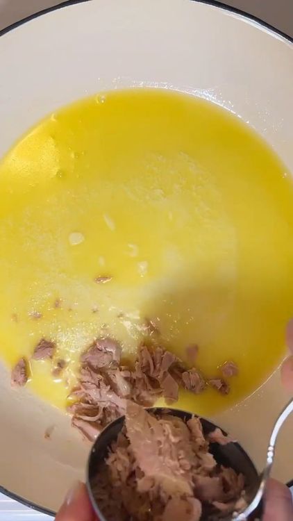 Step 1.2: Drain the liquid from the tuna and add it to the skillet