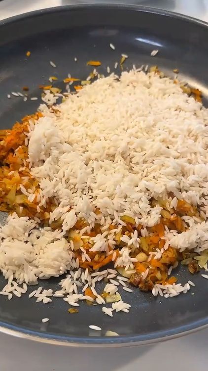 Step 2.1: Add cooked rice, tomato sauce, and water to the pan