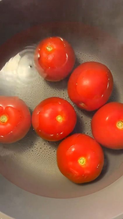 Step 1.1: Gently boil the tomatoes for a few minutes until the skins start to peel off
