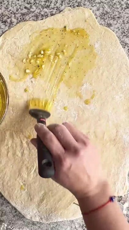Step 2.1: Spread the garlic and olive oil mixture evenly over the dough