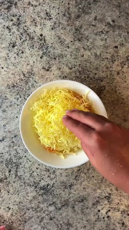 Step 1.1: Add the grated cheese to the eggs and mix lightly