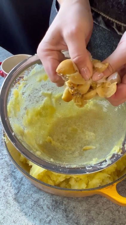 Step 2.1: Squeeze the roasted garlic cloves into the potatoes