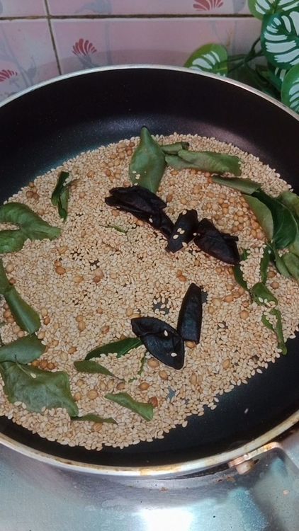 Step 1.2: In the same pan , dry roast sesame seeds, coriander seeds, few curry leaves
