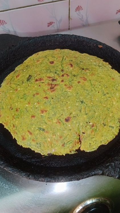 Step 1.1: Place the rolled paratha on the hot tawa