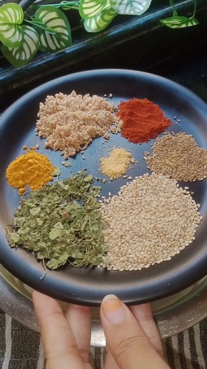 Step 1.2: In a large mixing bowl, combine Thalipeeth flour, peanut powder, red chilli powder, ajwain , sesame seeds, kasuri methi, turmeric powder and pinch of asafoetida