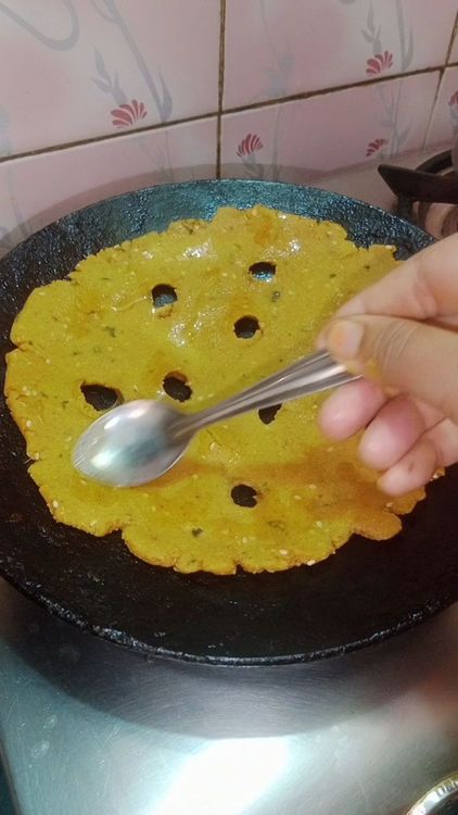 Step 1.1: Drizzle ghee or oil around the edges and cook on medium heat until golden brown spots appear on both sides