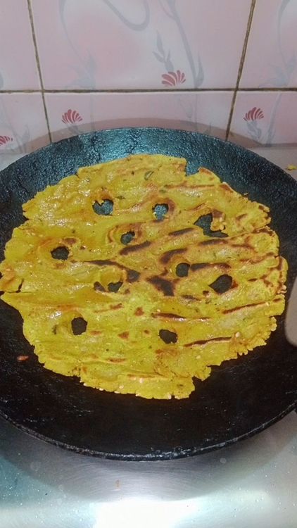 Step 1.2: Drizzle ghee or oil around the edges and cook on medium heat until golden brown spots appear on both sides
