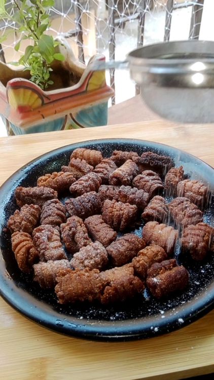 Step 1.1: Once cool, toss the kulkuls in powdered sugar to coat them evenly