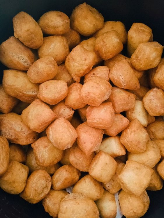 Step 1.1: Lay oil patching paper in a wide bowl, remove the mandazis from the fryer when ready, leave it to drain excess oil, and drop them on the bowl