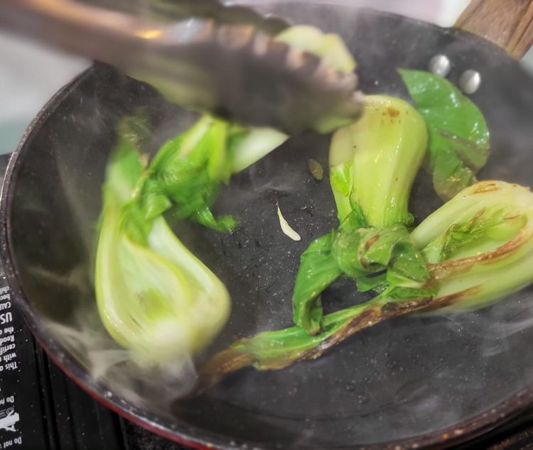 Step 1.1: Heat a pan, add a little vegetable oil, then flash fry the pak choi halves just to get some color