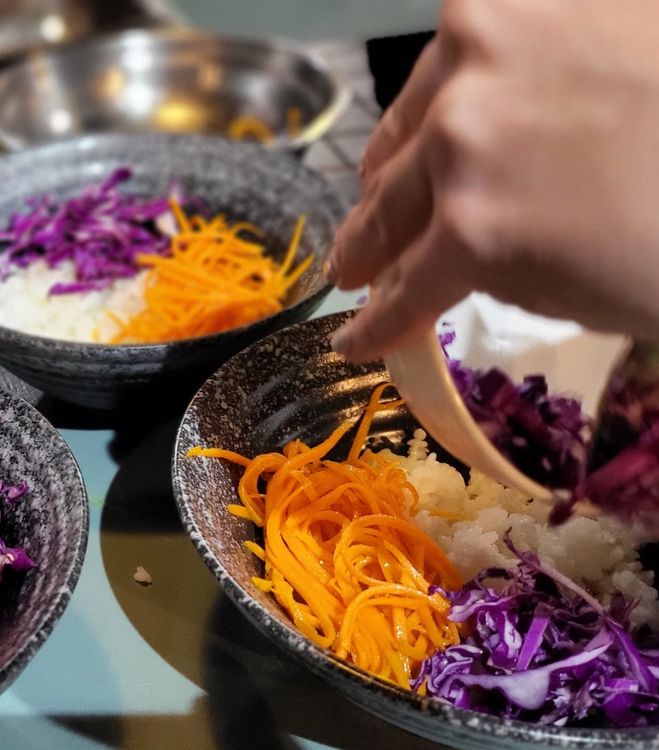 Step 1.1: Prepare your bowl: Place the sushi rice in the bowl, then arrange the carrots, red cabbage, and pak choi so you can see the colors