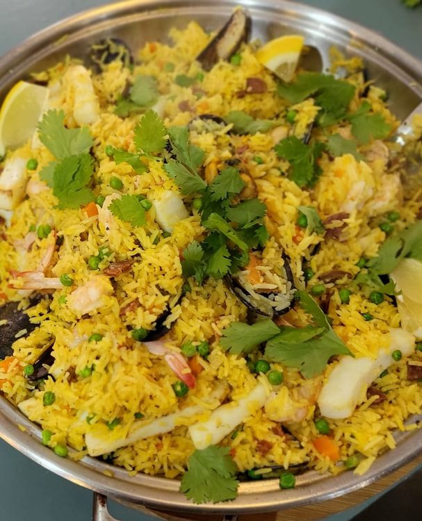 Step 1.1: Plate the paella and garnish with the lemon wedges and roughly chopped coriander